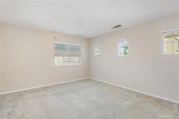 a view of an empty room and a window