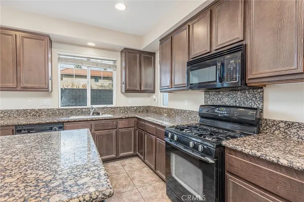 a kitchen with granite countertop kitchen island sink and center island