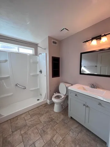 a bathroom with a toilet sink and shower