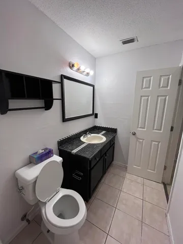 a bathroom with a sink a toilet and mirror