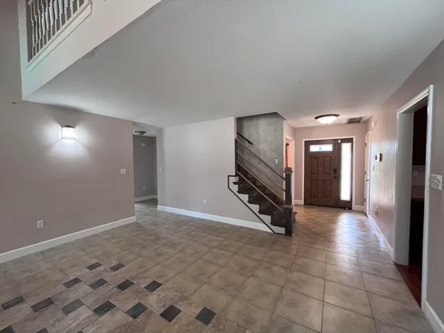 a view of a hallway with entryway door