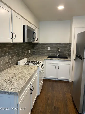 a view of room with window and wooden floor