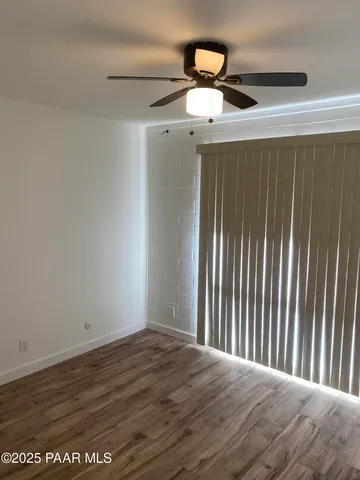 a view of a room with wooden floor