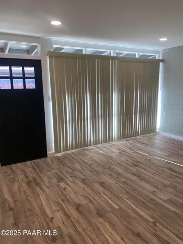 a view of a room with wooden floor