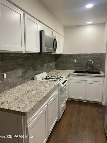 a kitchen with a sink and cabinets