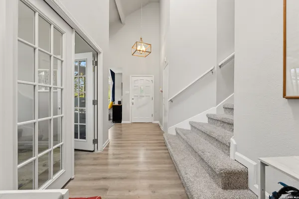 a view of a hallway with wooden floor and entryway