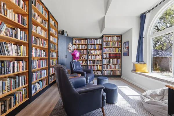 a living room with furniture and a book shelf