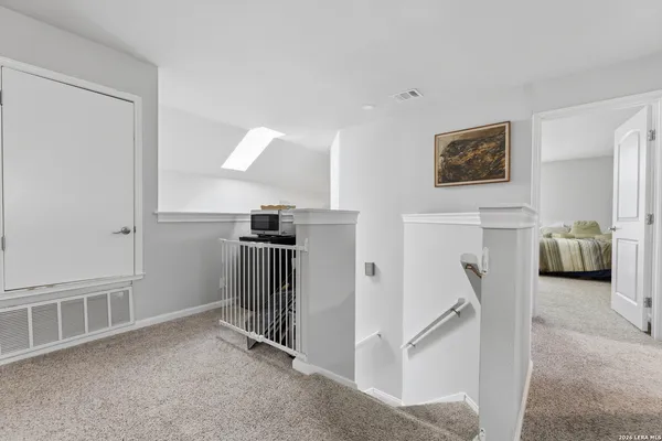 a view of a livingroom with furniture and a hallway