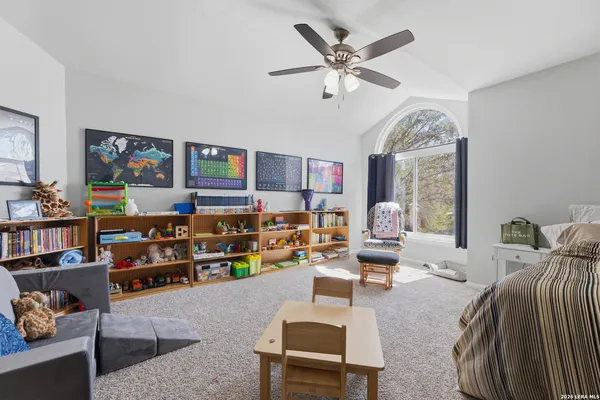 a living room with lots of furniture and ceiling fan