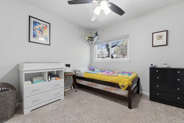 a bedroom with furniture and a baby crib