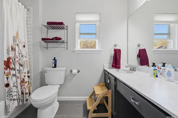 a bathroom with a sink vanity mirror and toilet