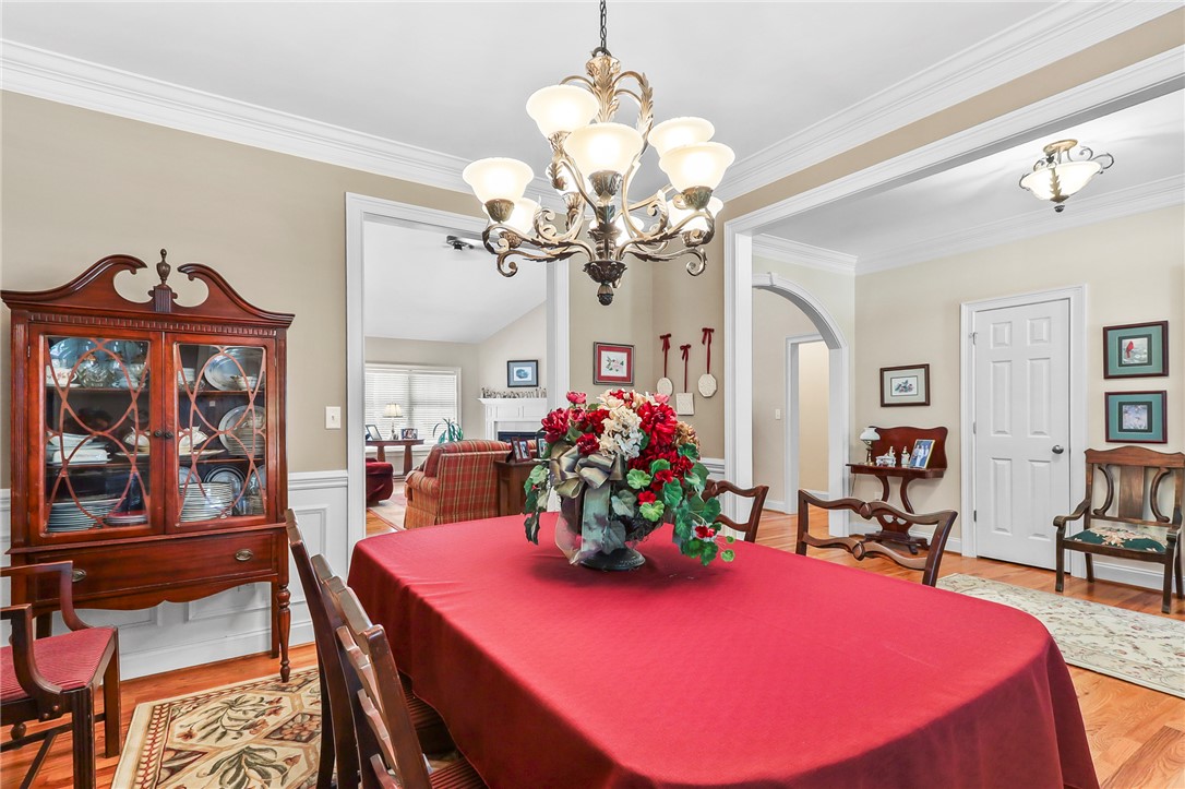 103 C-10-147D Anderson, SC 29621 - Photo 7 of 49 Ornate chandelier and rich hardwood floors define this inviting dining room, perfect for entertaining.