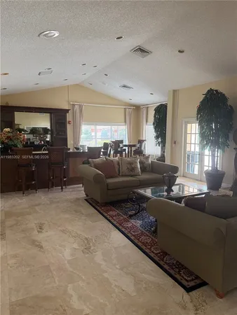 a living room with furniture fireplace and a large window