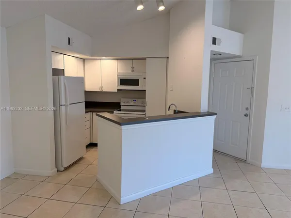 a kitchen with stainless steel appliances a refrigerator and a stove