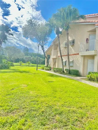 a view of swimming pool with lounge chair in front of house