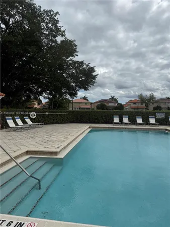 a view of swimming pool with outdoor seating and plants