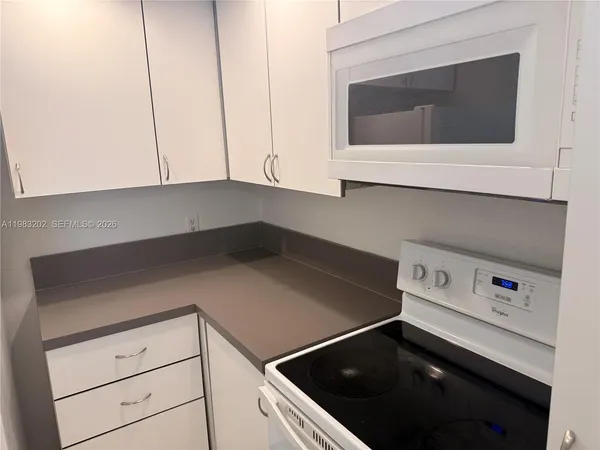 a kitchen with a microwave and cabinets