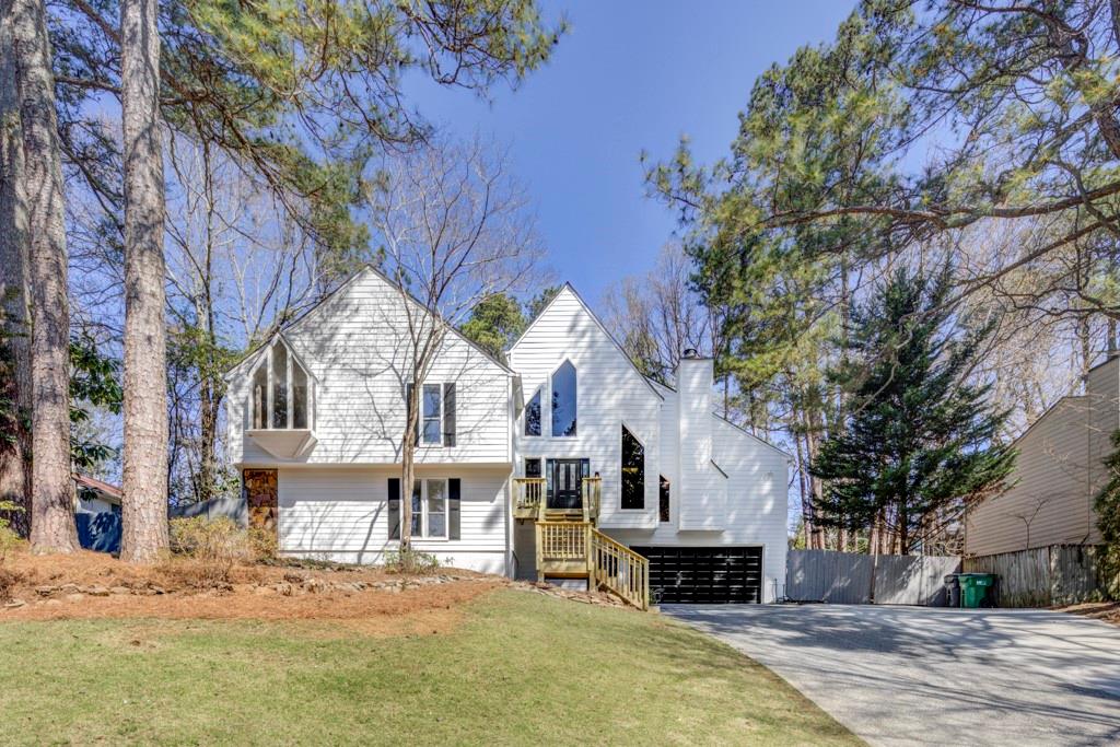a front view of a house with a yard covered with snow
