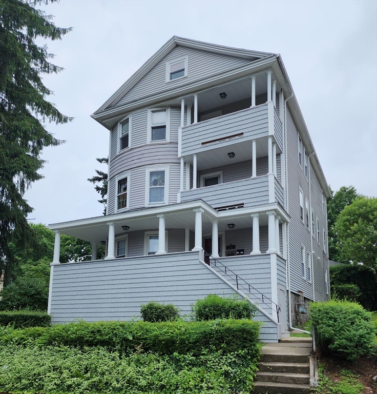 63 Fifth Avenue, Unit 1 Worcester, MA 01607 - Photo 12 of 13 a front view of a house with a yard