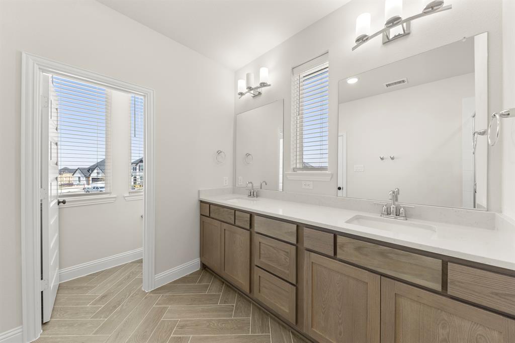 3900 Keya Drive Prosper, TX 75078 - Photo 30 of 36 a bathroom with a double vanity sink mirror and