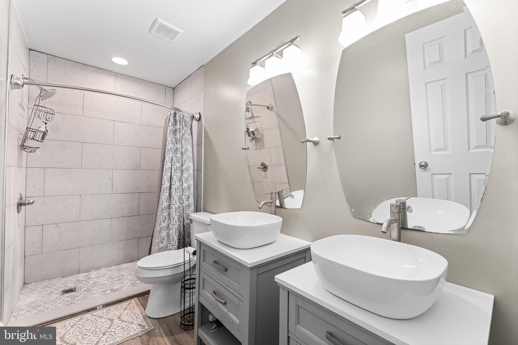 106 Bunning Drive Voorhees, NJ 08043 - Photo 32 of 45 a bathroom with a sink a toilet a mirror and shower