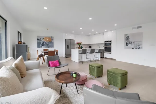 a living room with furniture kitchen view and a couch