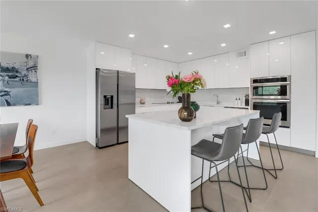 a dining room with furniture and a kitchen view
