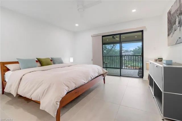 a spacious bedroom with a bed and a window