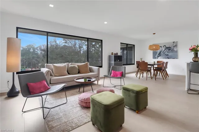 a living room with furniture and a floor to ceiling window