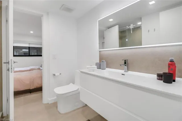 a bathroom with a toilet sink and mirror