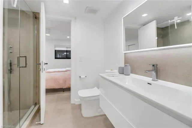 a bathroom with a sink a toilet and shower