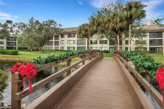 a view of a house with a yard and potted plants
