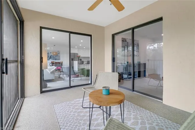 a living room with furniture and a glass door