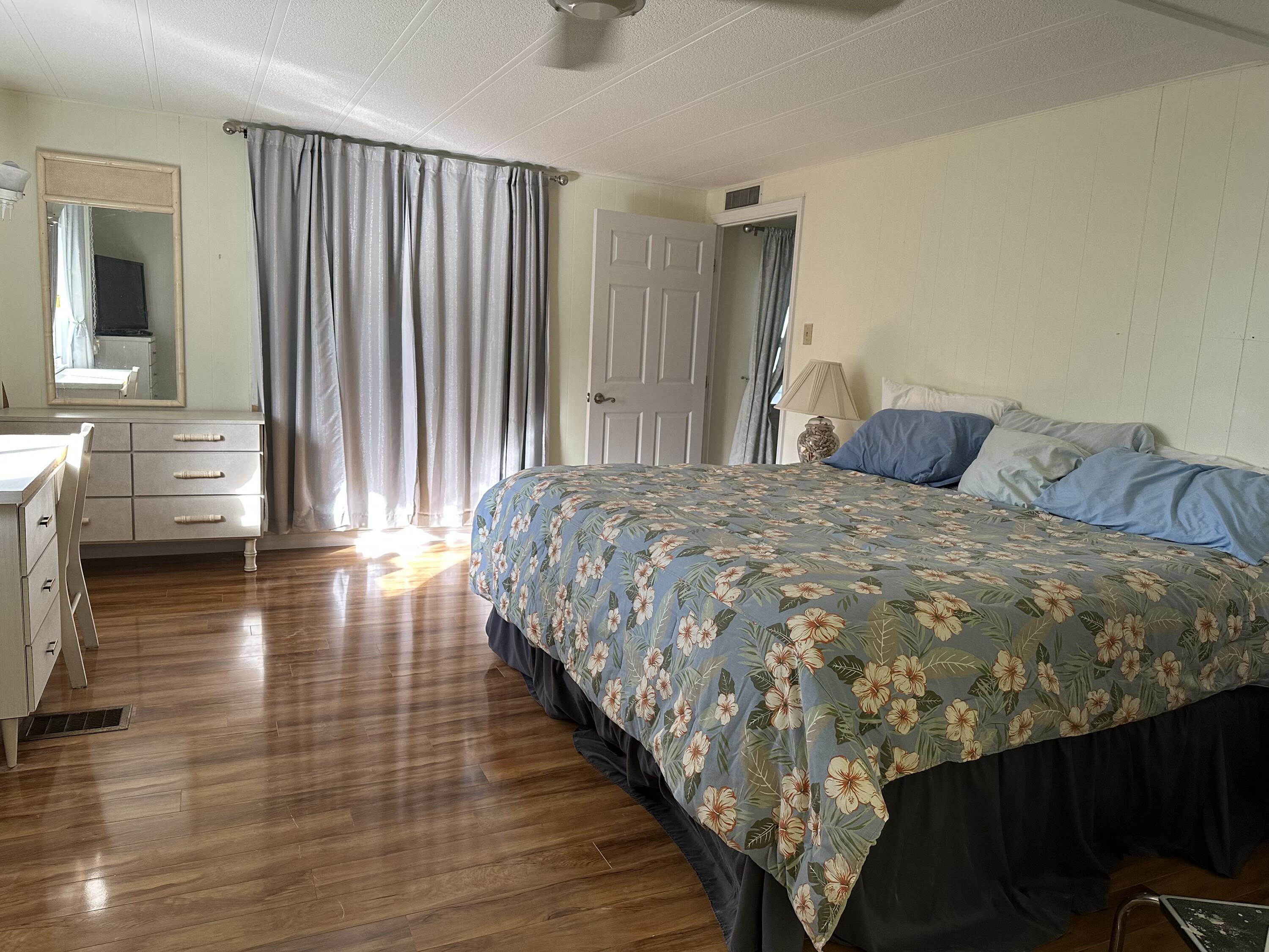 702 North Silver Circle Key Largo, FL 33037 - Photo 11 of 26 a bedroom with a bed and a view of wooden floor