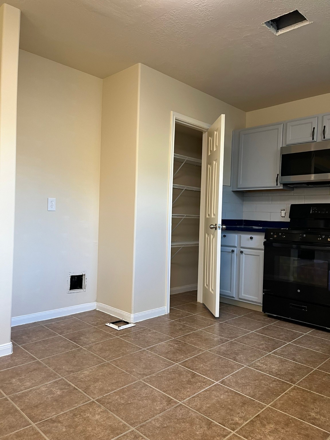 21650 Falvel Sunset Court Spring, TX 77388 - Photo 11 of 39 a view of a kitchen with white cabinets and a stove top oven