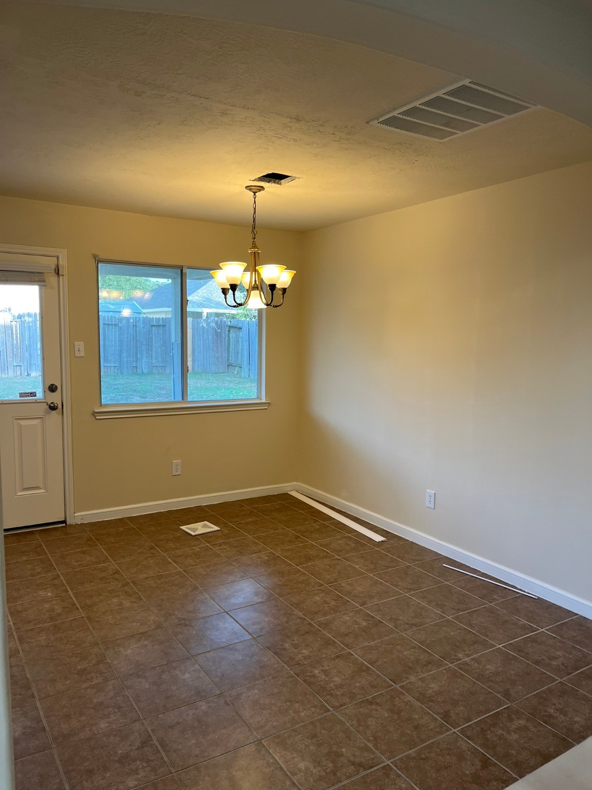 21650 Falvel Sunset Court Spring, TX 77388 - Photo 12 of 39 an empty room with chandelier fan and windows
