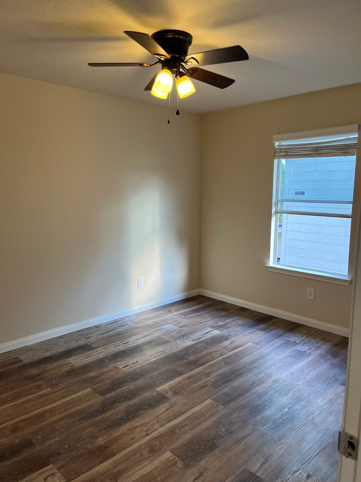 21650 Falvel Sunset Court Spring, TX 77388 - Photo 24 of 39 a view of an empty room with wooden floor and a window