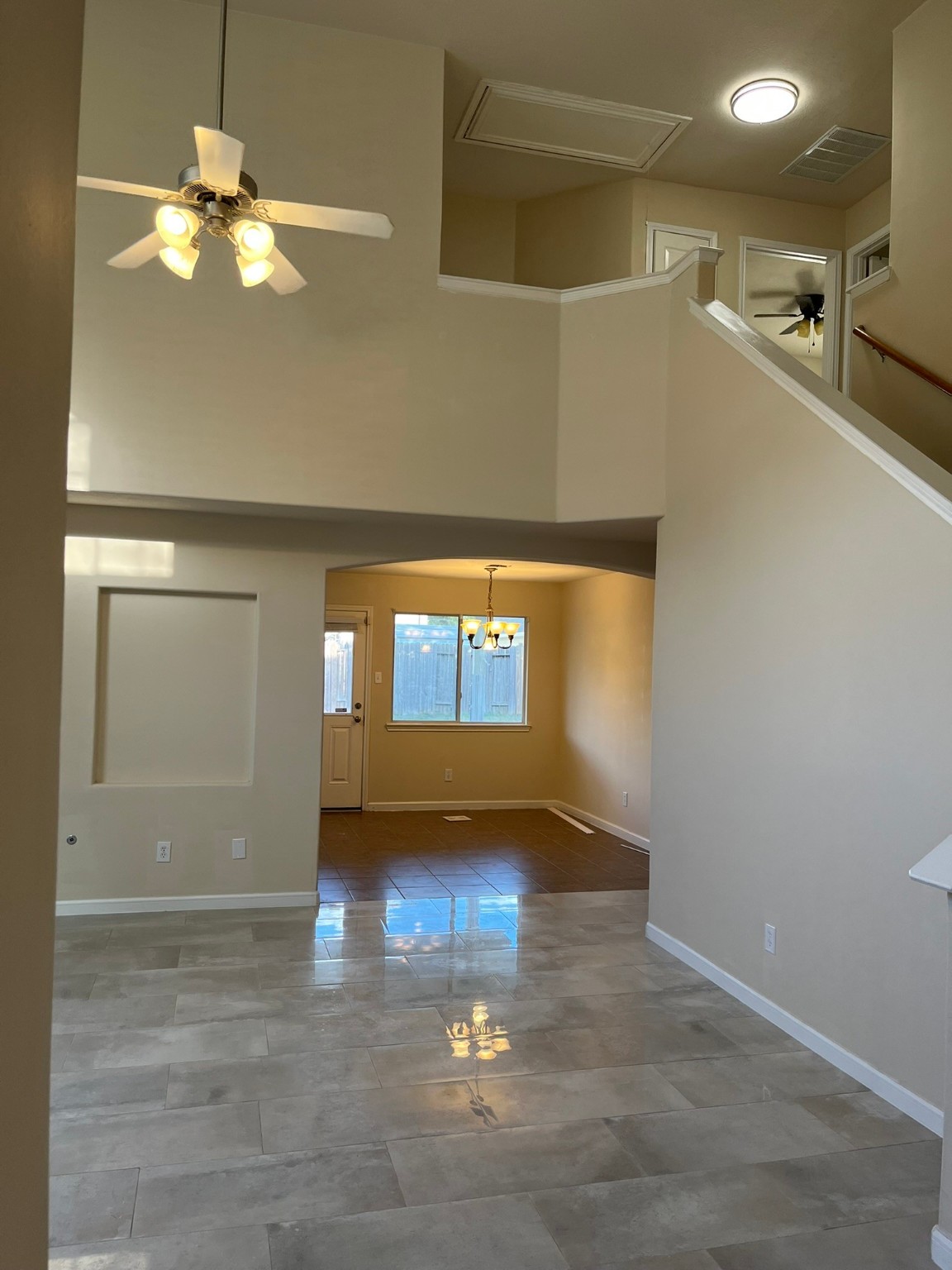 21650 Falvel Sunset Court Spring, TX 77388 - Photo 4 of 39 a view of a hallway with wooden floor and a chandelier