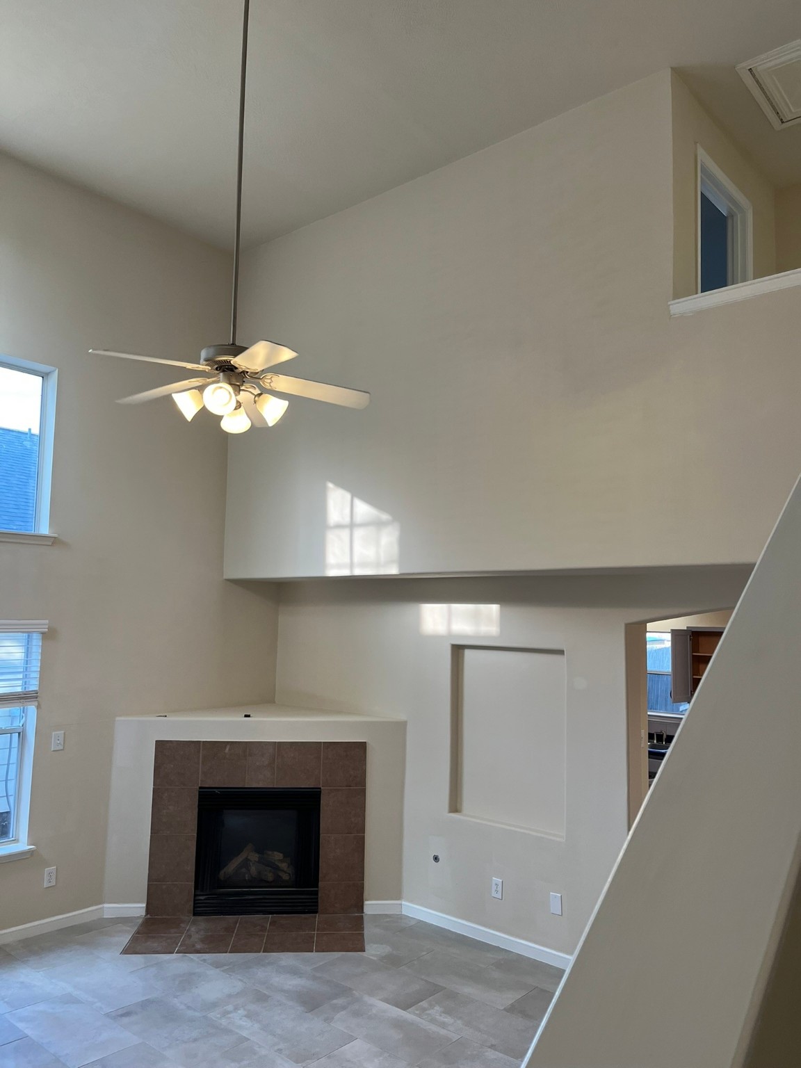 21650 Falvel Sunset Court Spring, TX 77388 - Photo 5 of 39 a view of a livingroom with a fireplace a chandelier and stairs