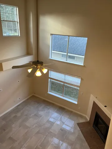 a view of a room that has a window and wooden floor