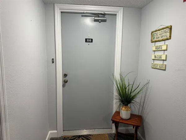 a view of room with a potted plant on the wall and mirror