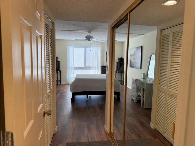 a view of a hallway and wooden floor and a livingroom with furniture