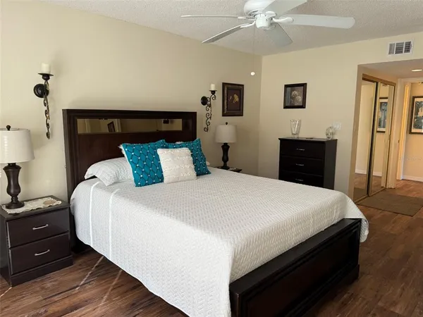 a bedroom with a bed and a chandelier