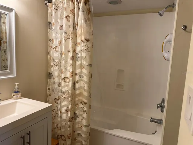 a bathroom with a shower curtain and a sink