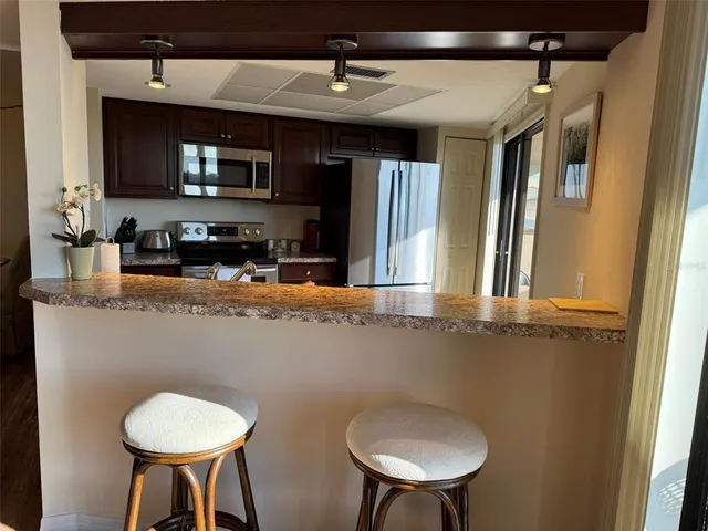 a kitchen with a sink a microwave and cabinets