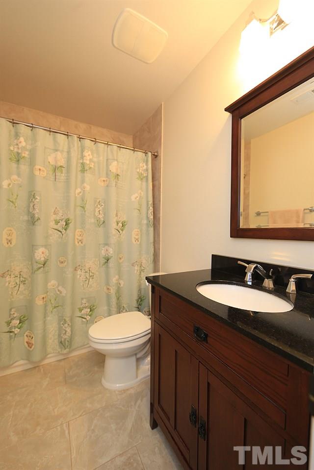 861 Bethlehem Church Road Youngsville, NC 27596 - Photo 11 of 25 a bathroom with a granite countertop sink toilet and mirror