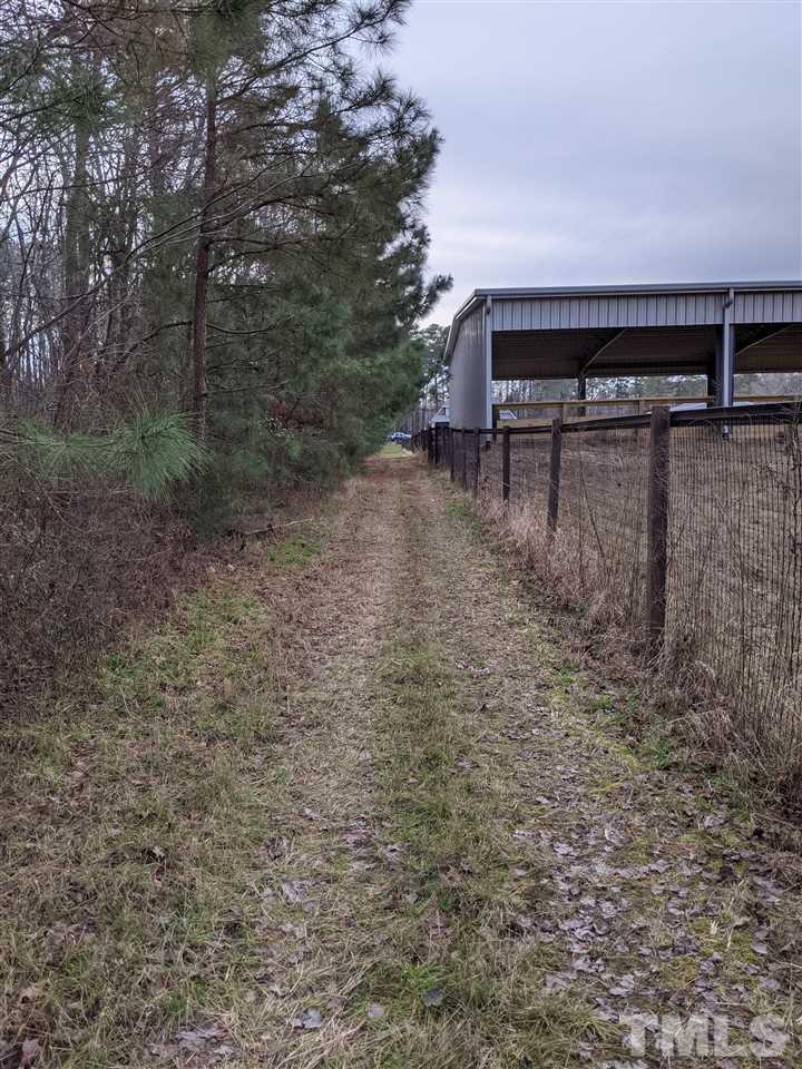 861 Bethlehem Church Road Youngsville, NC 27596 - Photo 25 of 25 a view of a yard with a bench and trees