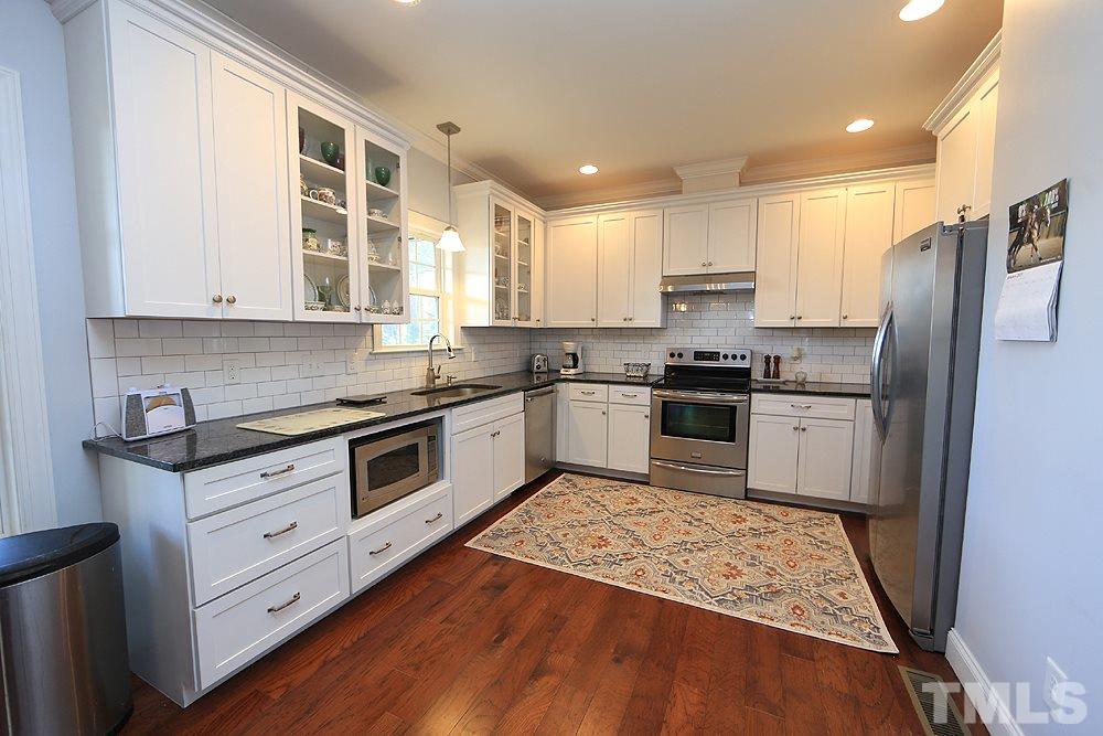861 Bethlehem Church Road Youngsville, NC 27596 - Photo 5 of 25 a kitchen with stainless steel appliances granite countertop a stove a sink and a refrigerator