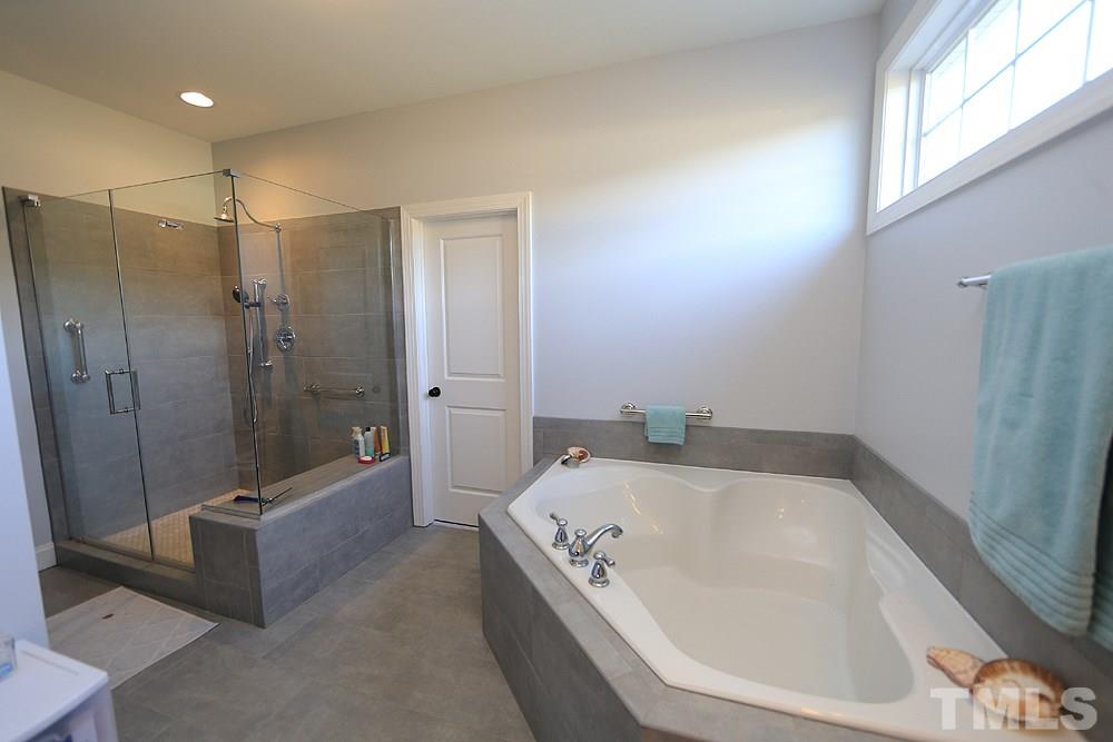 861 Bethlehem Church Road Youngsville, NC 27596 - Photo 8 of 25 a bathroom with a bathtub and a shower