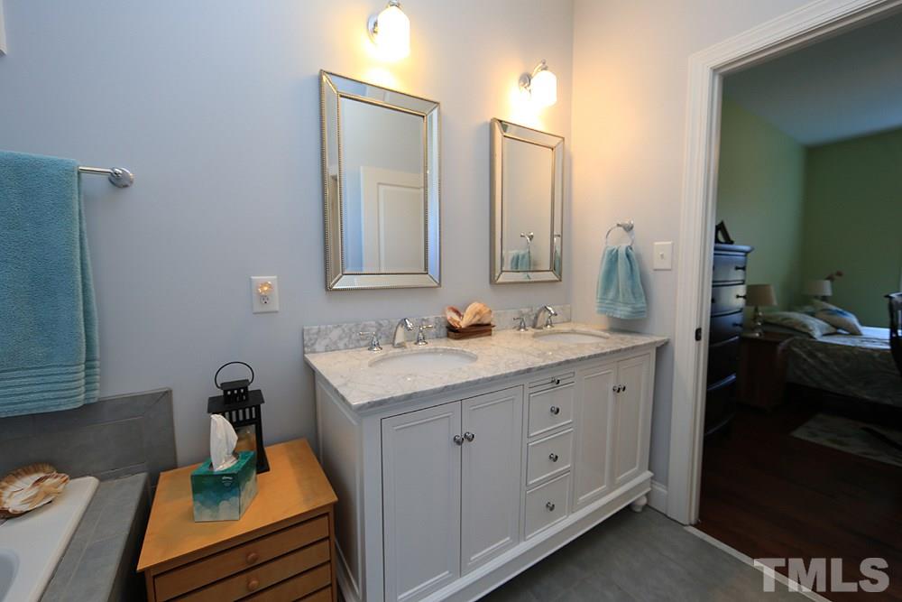 861 Bethlehem Church Road Youngsville, NC 27596 - Photo 9 of 25 a bathroom with a granite countertop sink and a mirror